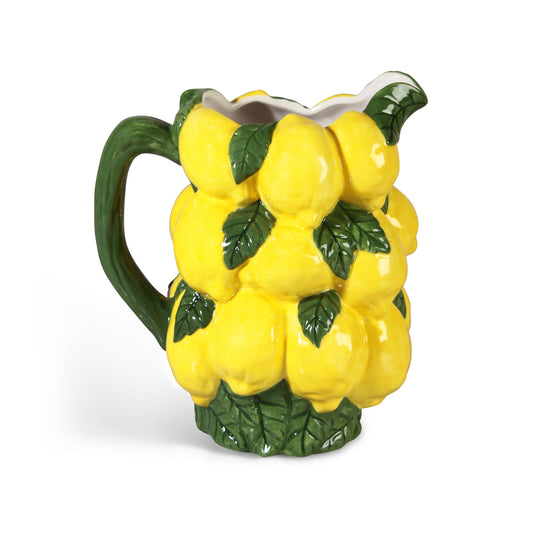 A yellow and green lemon jug on a white seamless background.