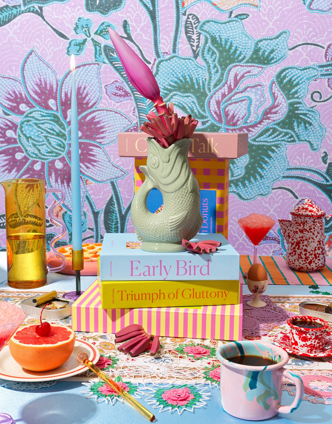 A vibrant brunch-inspired gift selection featuring stylish puzzle boxes, artisanal treats, fresh fruit, chic glassware, and eclectic table decor—perfect for brunch lovers and unique, wow-worthy gifting.